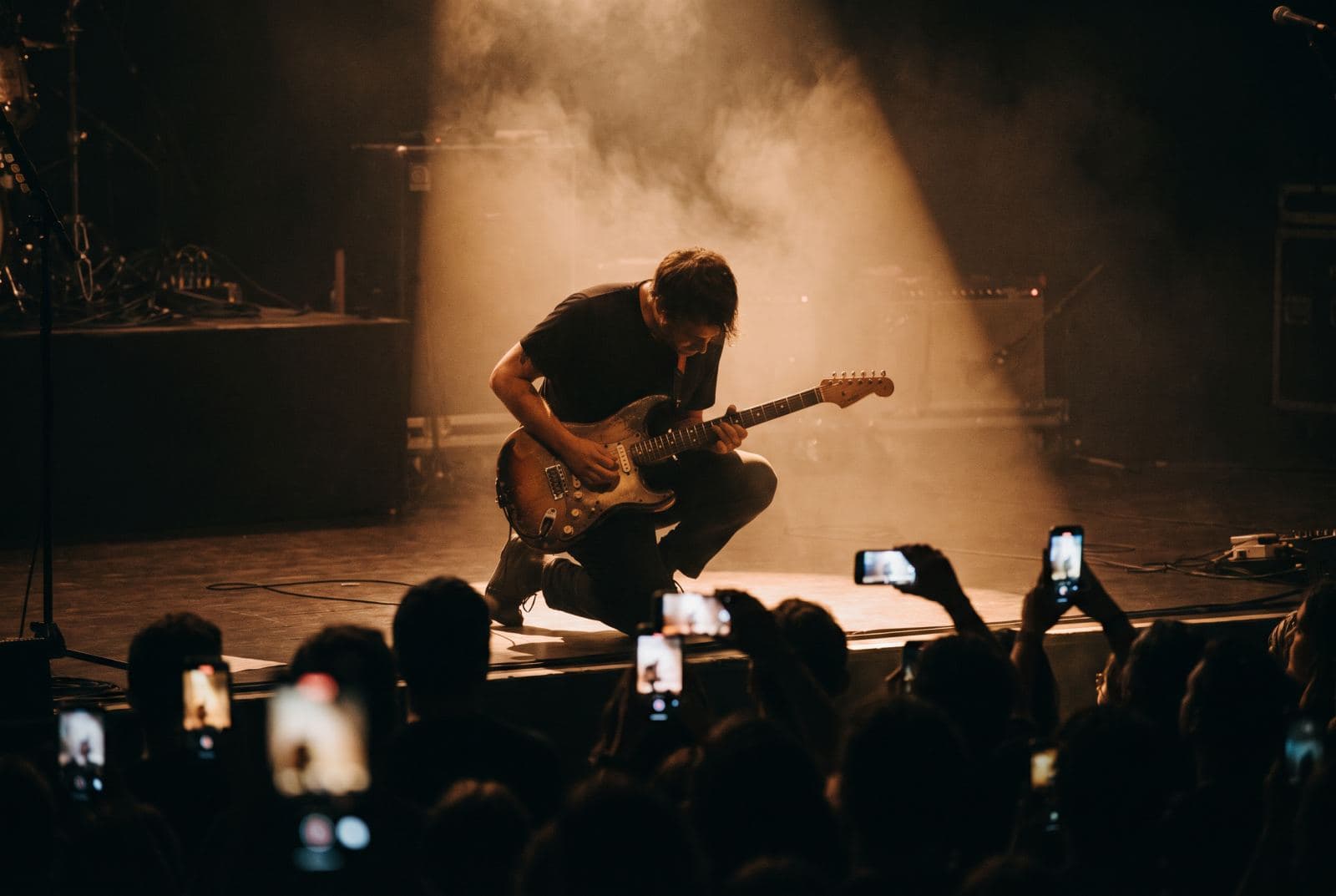 A musician performing on a dark stage